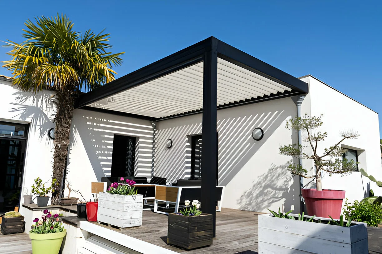 Motorized louvered pergola in Miami: blades tilted closed with integrated gutter system